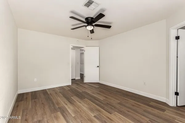 a spacious bedroom with a bed and a couch