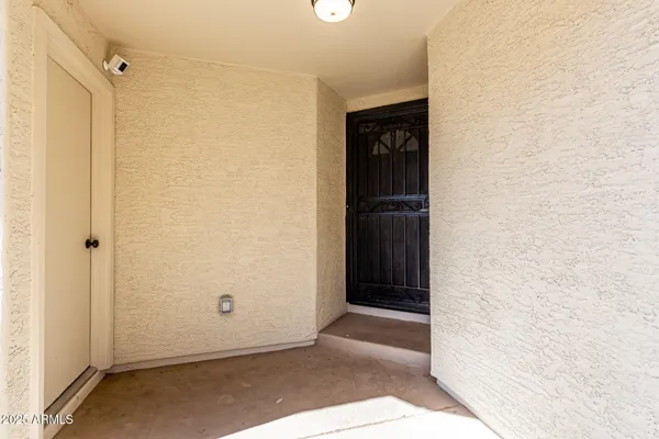 a view of a house with a wooden fence