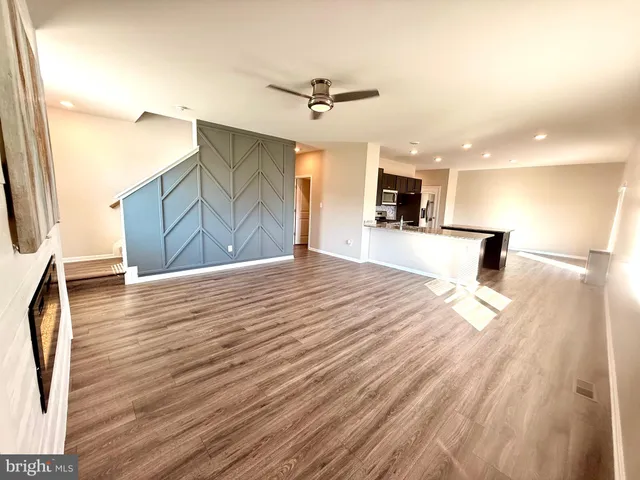 a kitchen with kitchen island granite countertop a stove a sink and a refrigerator