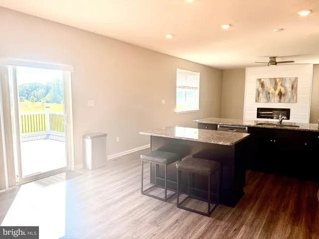 a kitchen with stainless steel appliances granite countertop a sink stove microwave and refrigerator