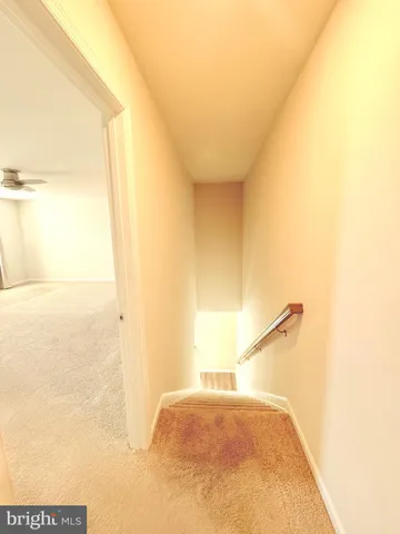 a bathroom with a toilet and a mirror