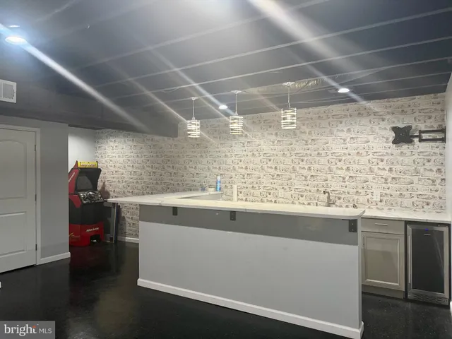 a view of a small space with wooden floor and a window