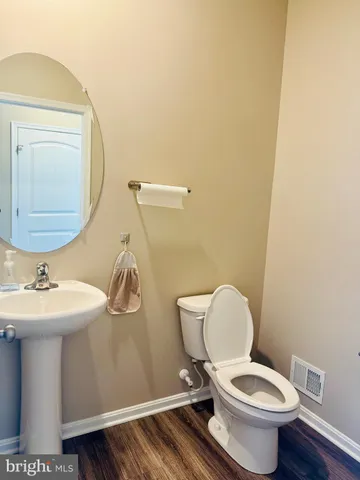 a view of a livingroom with wooden floor and a ceiling fan