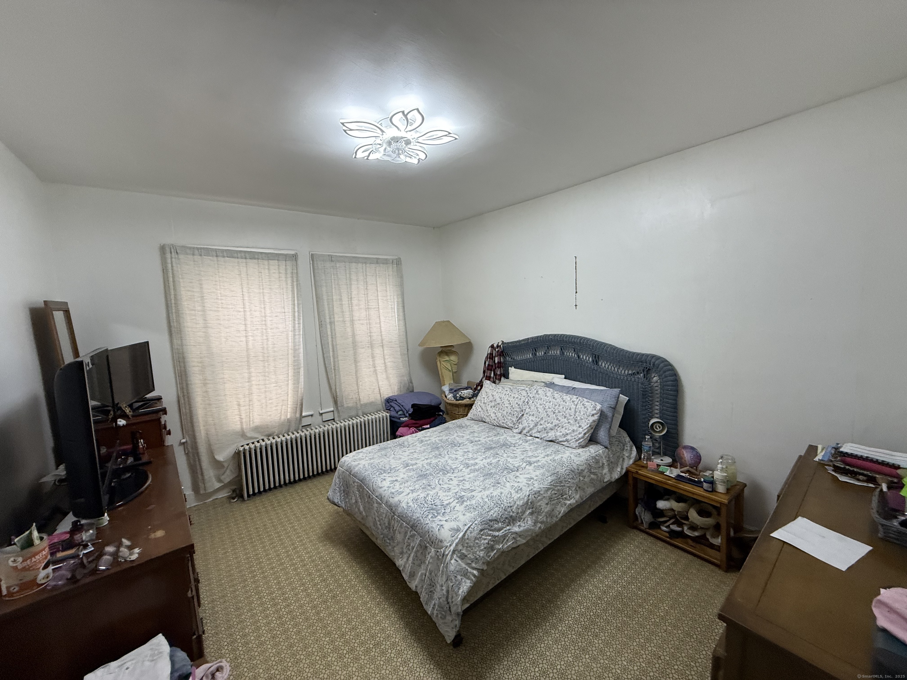 60 Capitol Avenue Meriden, CT 06451 - Photo 3 of 10 a bedroom with a bed and wooden floor