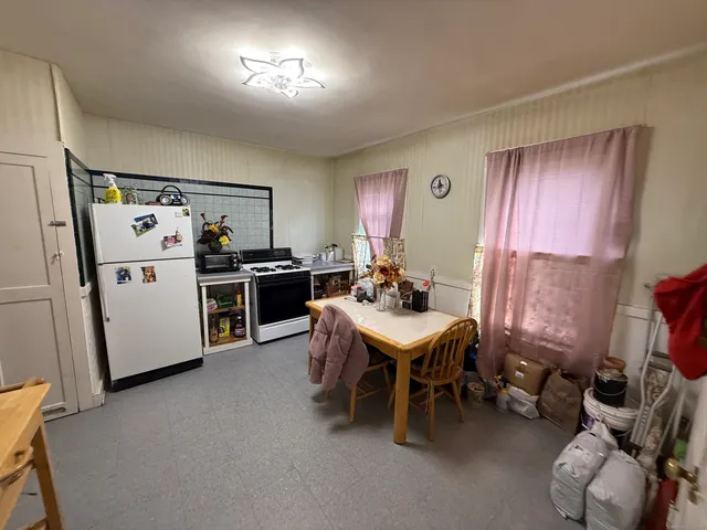 a kitchen that has a sink and a refrigerator