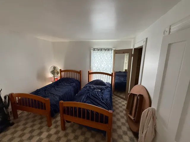 a bedroom with furniture and a window