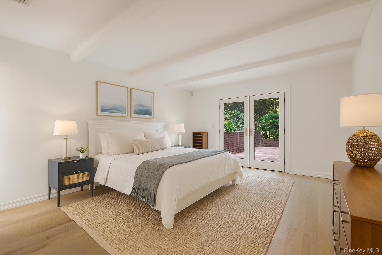 40 Nidzyn Avenue Remsenburg, NY 11960 - Photo 15 of 28 Bedroom with beam ceiling, light wood-style flooring, access to exterior, and french doors