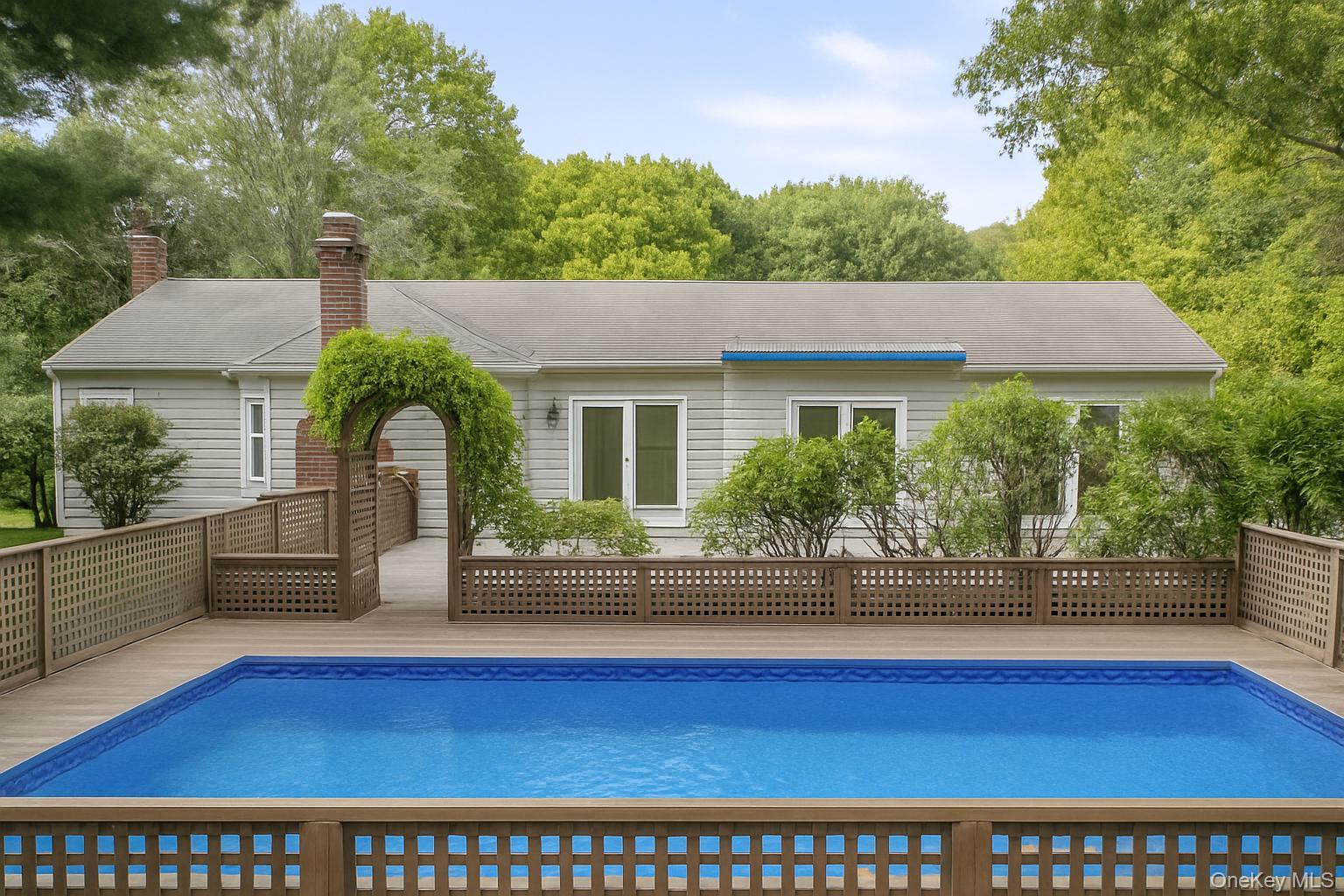 40 Nidzyn Avenue Remsenburg, NY 11960 - Photo 2 of 28 View of swimming pool with a wooden deck