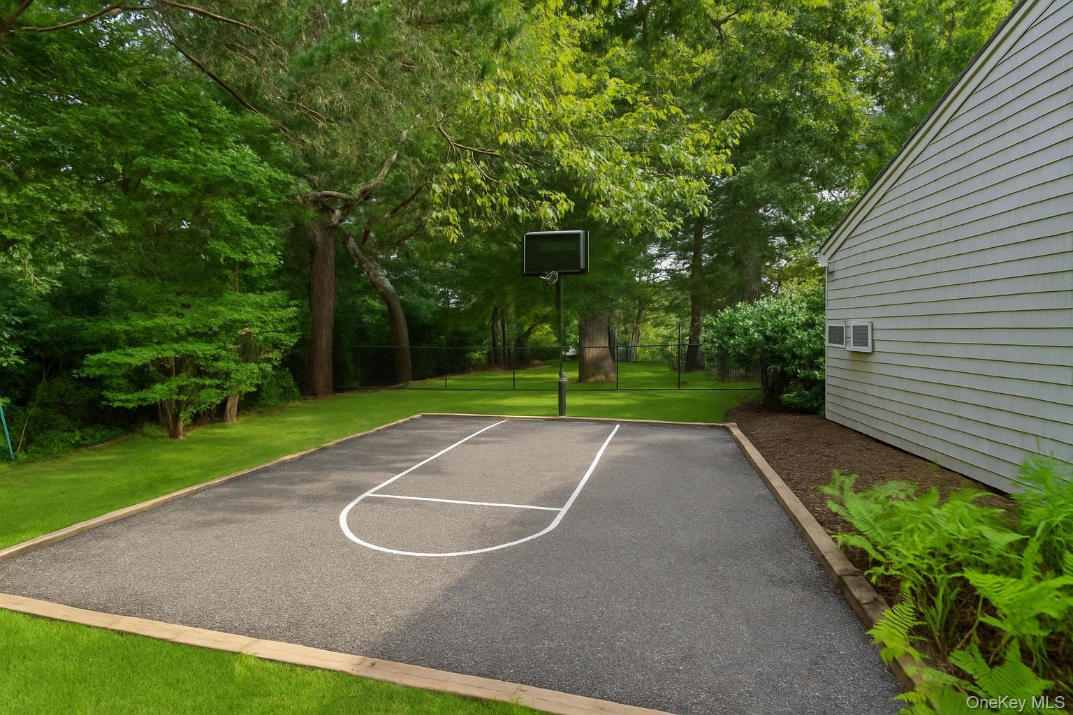 40 Nidzyn Avenue Remsenburg, NY 11960 - Photo 25 of 28 View of basketball court with view of wooded area and basketball hoop