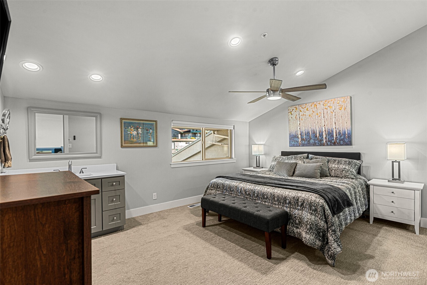 8997 Crescent Bar Road Northwest, Unit 219 Quincy, WA 98848 - Photo 30 of 40 a spacious bedroom with a large bed and a chandelier