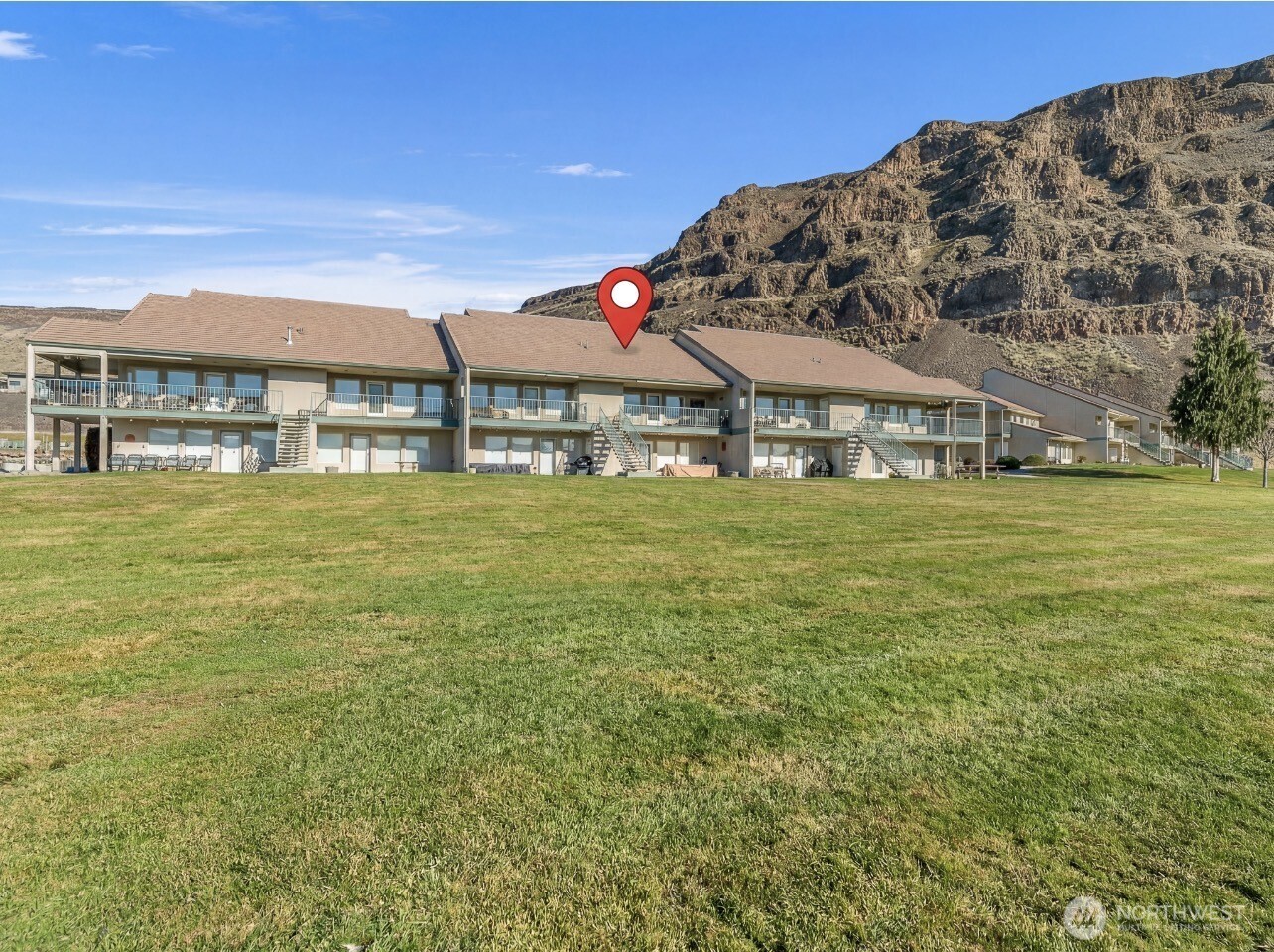 8997 Crescent Bar Road Northwest, Unit 219 Quincy, WA 98848 - Photo 3 of 40 a view of a large building with a big yard