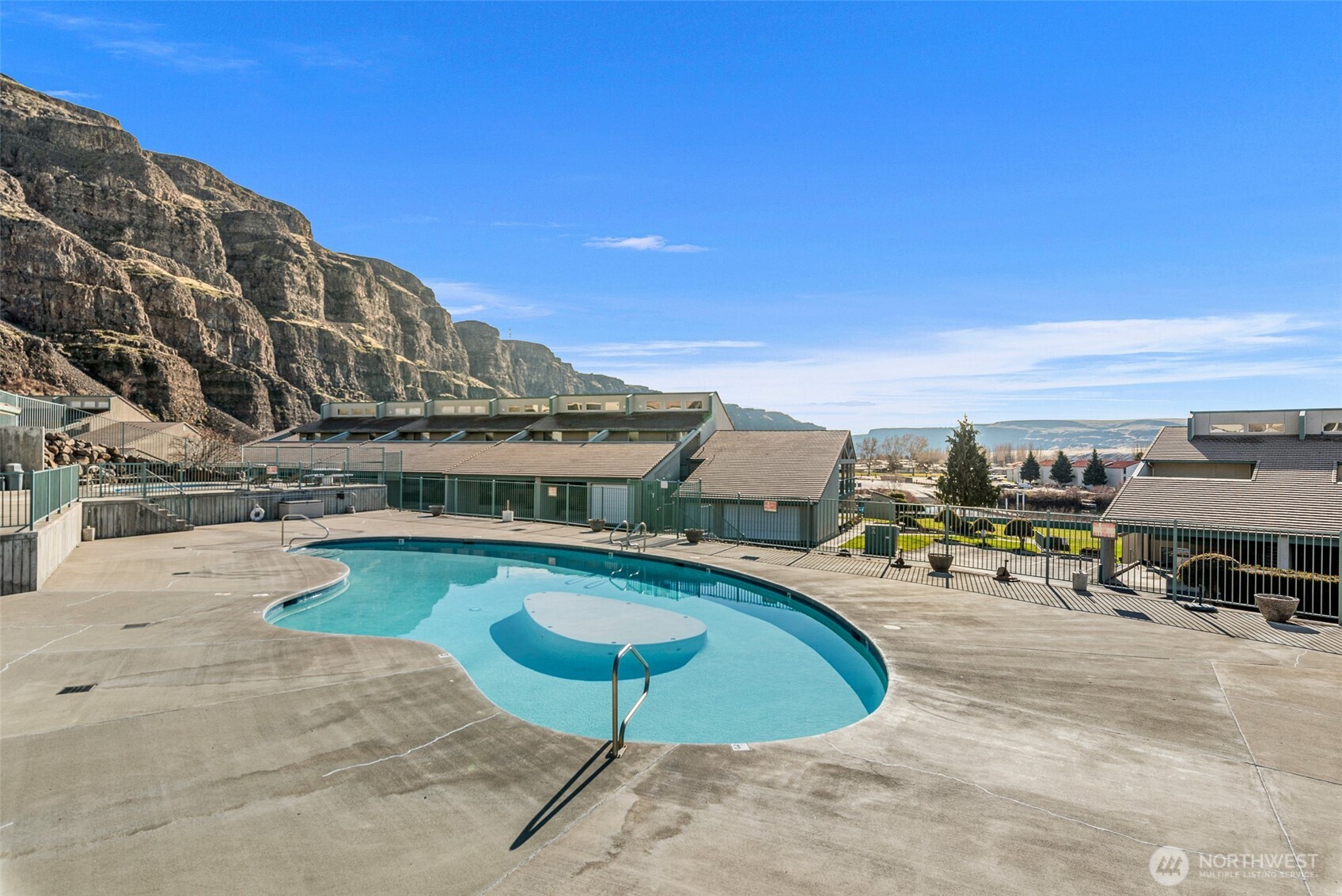 8997 Crescent Bar Road Northwest, Unit 219 Quincy, WA 98848 - Photo 39 of 40 a swimming pool with outdoor seating and city view