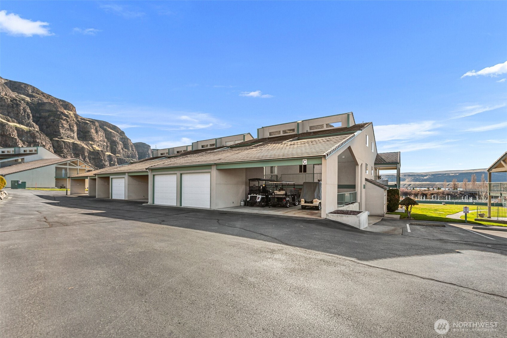 8997 Crescent Bar Road Northwest, Unit 219 Quincy, WA 98848 - Photo 8 of 40 a view of a house with a patio and a yard