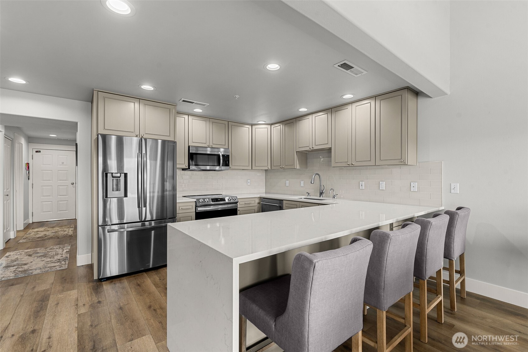 8997 Crescent Bar Road Northwest, Unit 219 Quincy, WA 98848 - Photo 10 of 40 a kitchen with stainless steel appliances a refrigerator stove microwave and cabinets