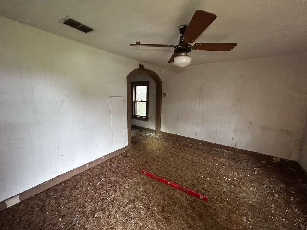 817 Miller Avenue Spur, TX 79370 - Photo 5 of 6 en empty room with ceiling fan and window