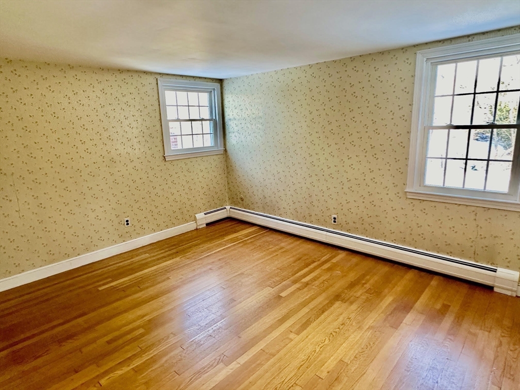 105 Marrett Road Lexington, MA 02421 - Photo 11 of 12 a view of a room with wooden floor and a window