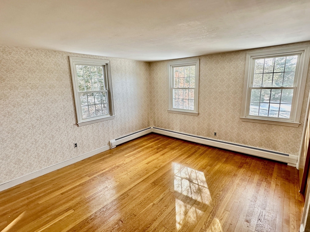 105 Marrett Road Lexington, MA 02421 - Photo 12 of 12 a view of empty room with wooden floor and fan