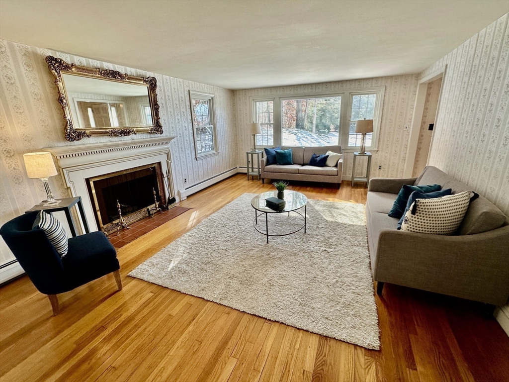 105 Marrett Road Lexington, MA 02421 - Photo 3 of 12 a living room with furniture and a fireplace