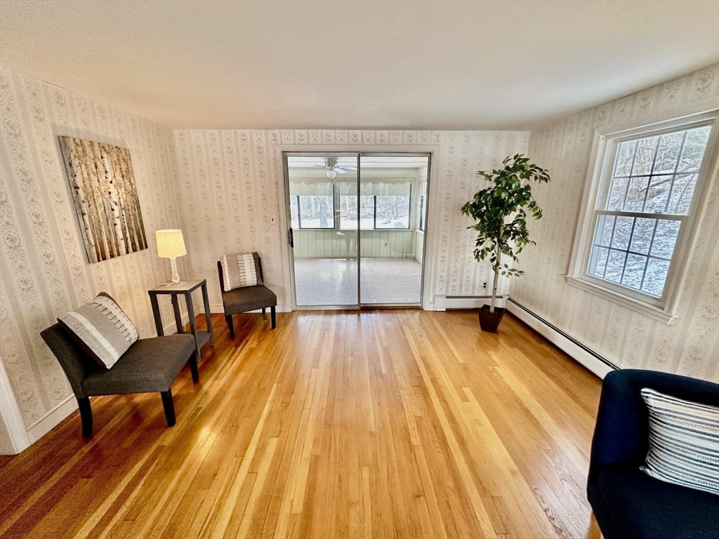 105 Marrett Road Lexington, MA 02421 - Photo 4 of 12 a spacious bedroom with a bed and wooden floor