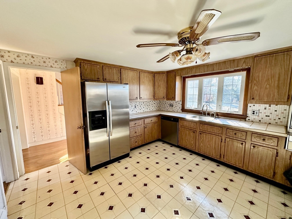 105 Marrett Road Lexington, MA 02421 - Photo 6 of 12 a kitchen with granite countertop a sink a counter space cabinets and stainless steel appliances