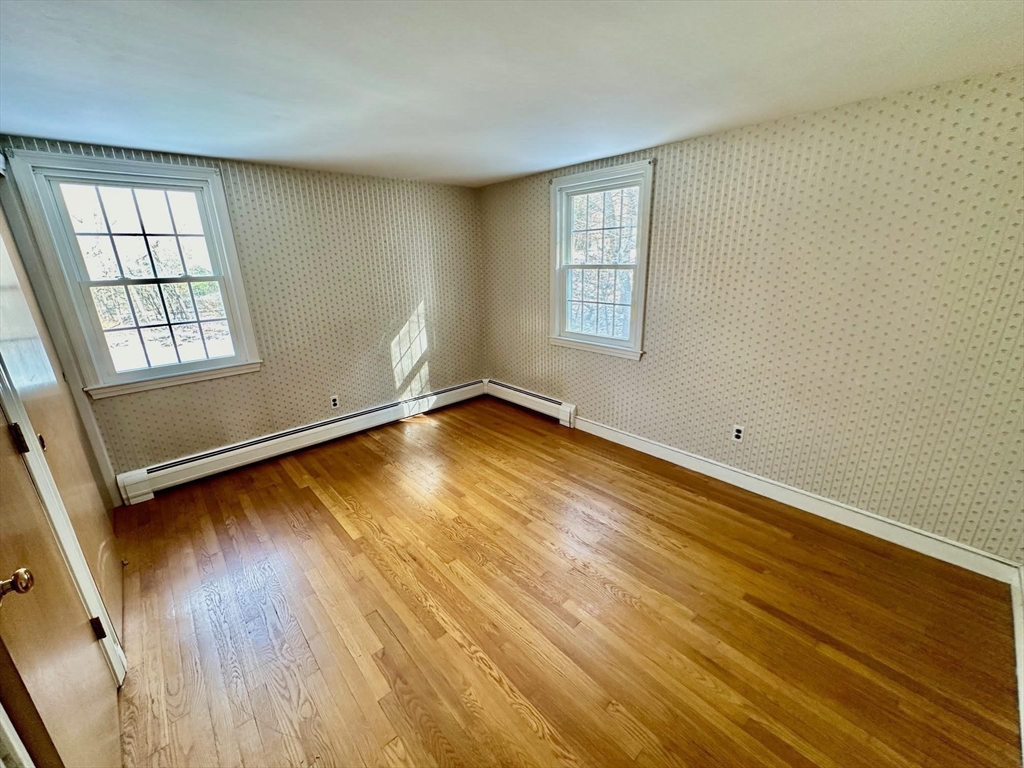105 Marrett Road Lexington, MA 02421 - Photo 10 of 12 an empty room with wooden floor and windows
