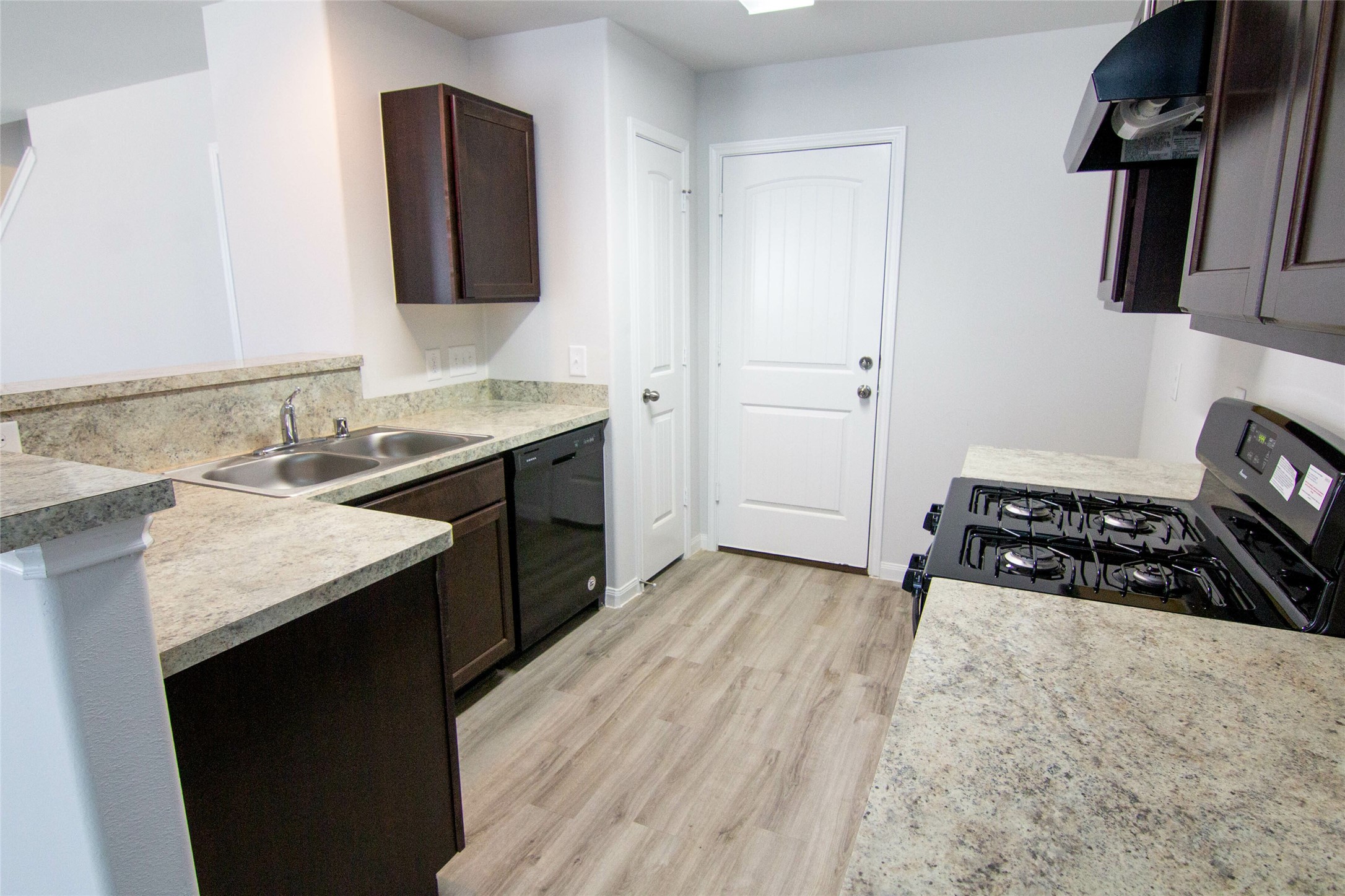 18611 Bell Ravine Drive Katy, TX 77449 - Photo 4 of 12 a kitchen with a sink stove and cabinets