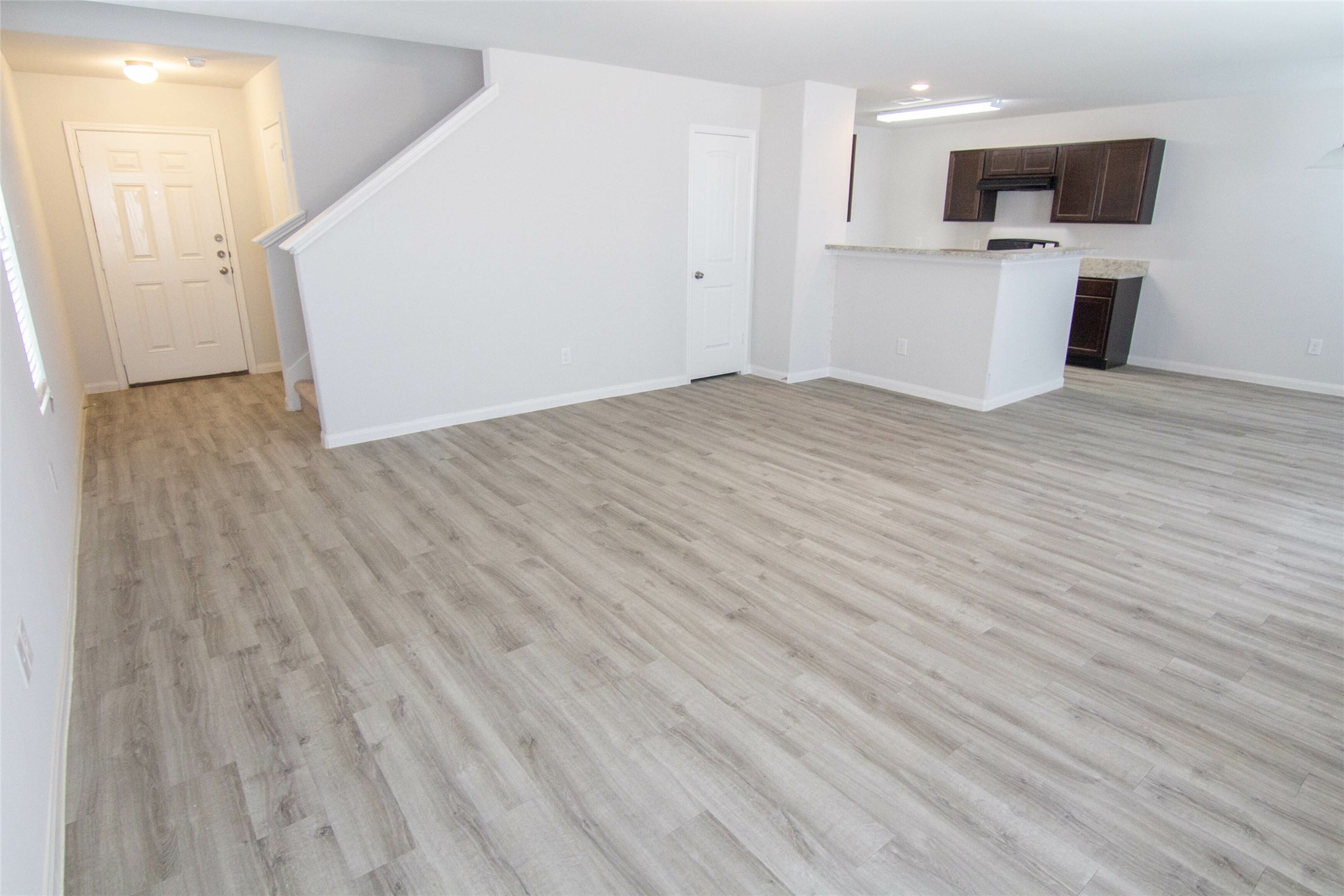 18611 Bell Ravine Drive Katy, TX 77449 - Photo 6 of 12 a view of a kitchen with microwave and white cabinets