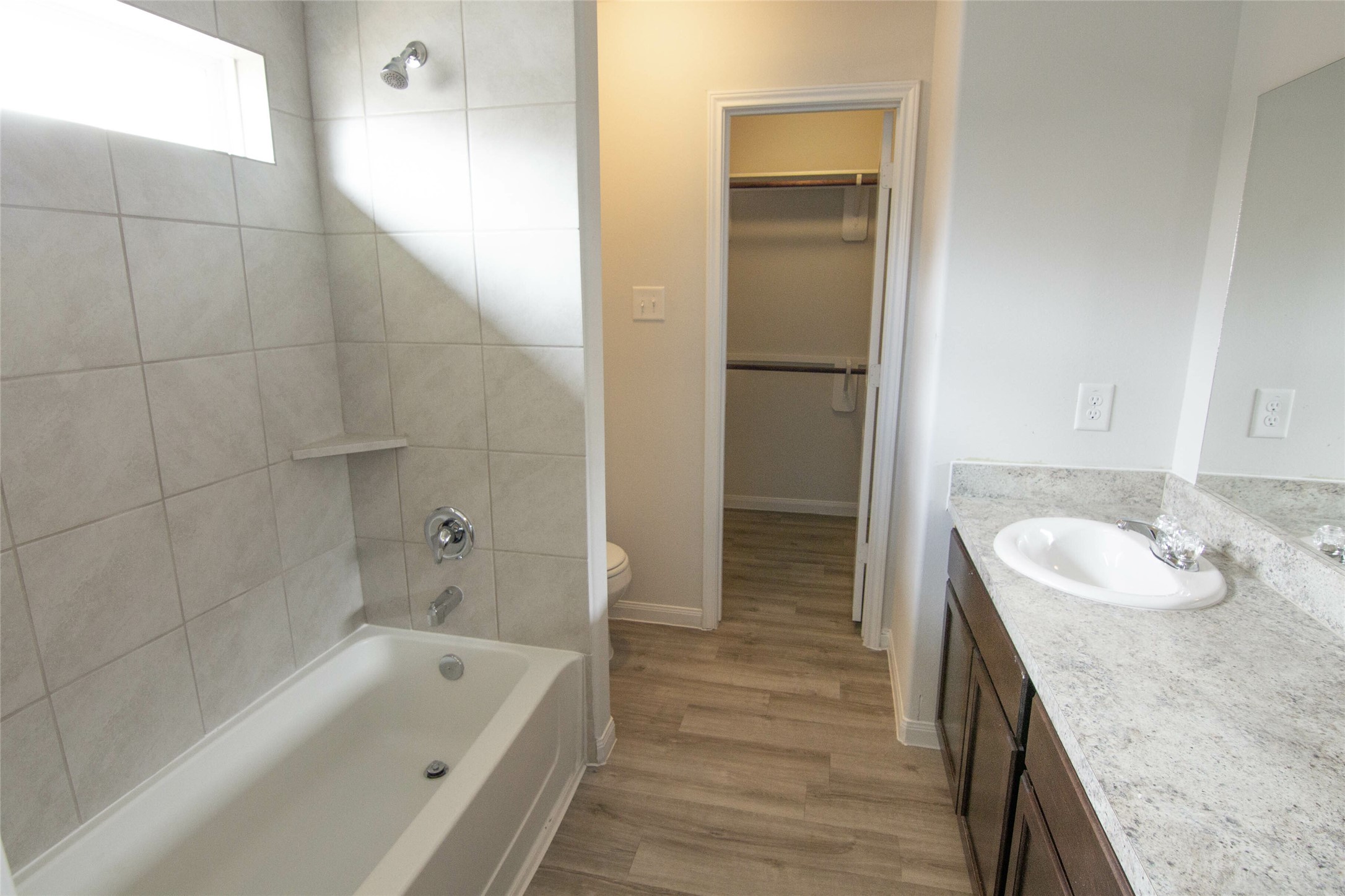 18611 Bell Ravine Drive Katy, TX 77449 - Photo 10 of 12 a bathroom with a granite countertop tub sink and mirror