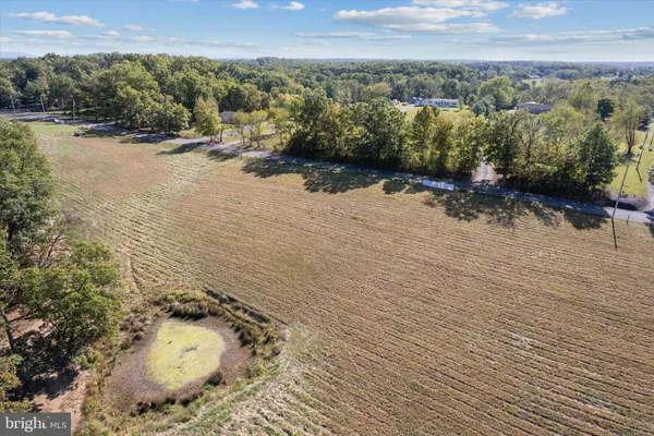 an aerial view of a houses with a yard