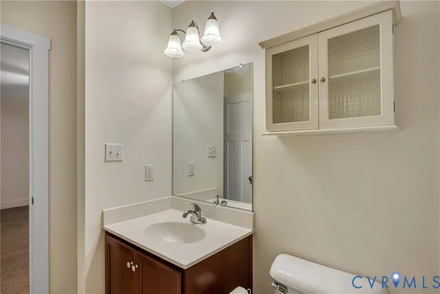 a bathroom with a sink a toilet and mirror