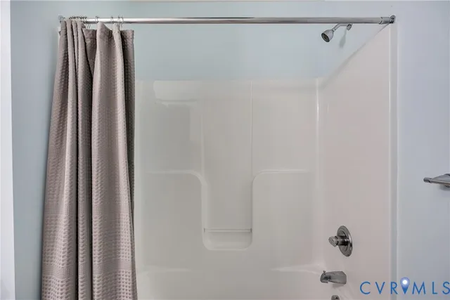 a bathroom with a shower and a shower