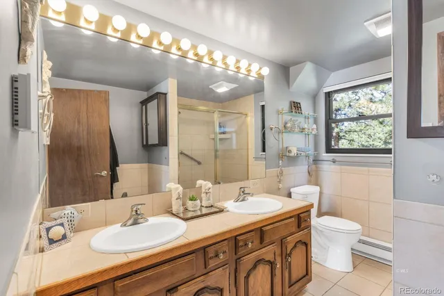 a bathroom with a sink vanity granite and toilet