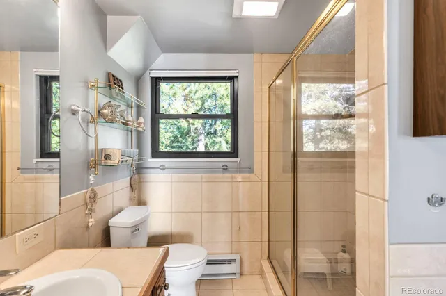 a bathroom with a toilet a sink and a shower