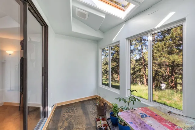 a bathroom with a sink a toilet and a window