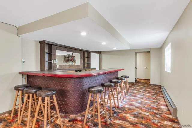 a room with pool table and wooden floor