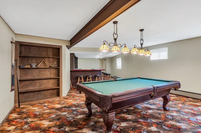 a bathroom with a granite countertop toilet sink and mirror