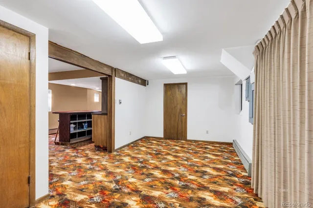a view of a roof deck with table and chairs and wooden floor
