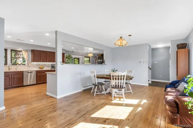 a view of a dining room with furniture and wooden floor