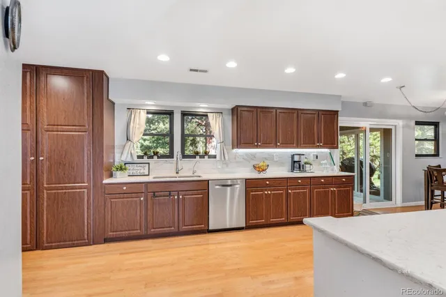a large kitchen with kitchen island granite countertop a large window