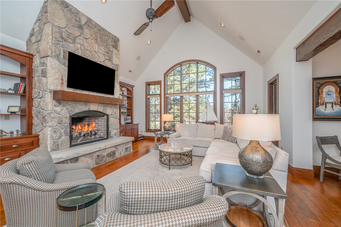 215 Long Ridge Road Sunset, SC 29685 - Photo 5 of 50 This airy living area features a stone fireplace, high vaulted ceilings, and extensive window views.