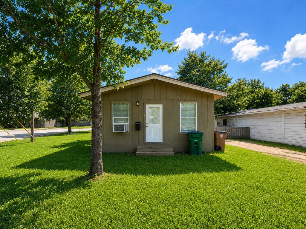 610 Gunter Street Austin, TX 78702 - Photo 1 of 16 A modest home with a fresh lawn and mature trees, offering quiet neighborhood living.