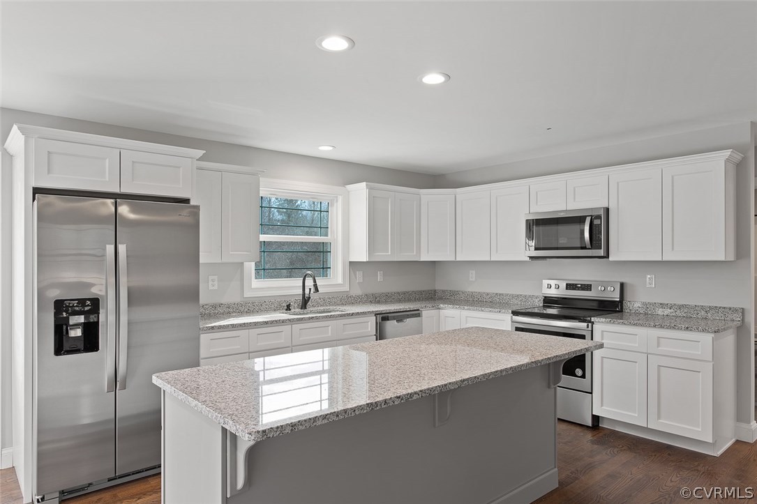 116 Diggstown Road Bumpass, VA 23024 - Photo 6 of 20 a kitchen with white cabinets and stainless steel appliances