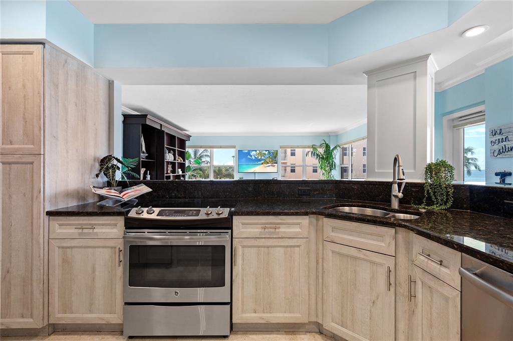 603 Longboat Club Road, Unit 304N Longboat Key, FL 34228 - Photo 11 of 43 a kitchen with granite countertop a sink and cabinets