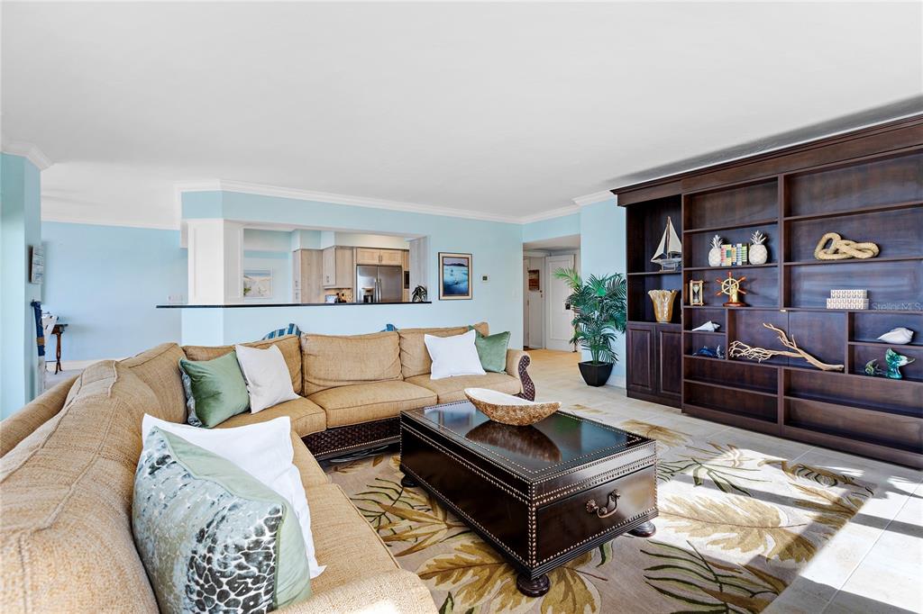 603 Longboat Club Road, Unit 304N Longboat Key, FL 34228 - Photo 5 of 43 a living room with furniture and a book shelf