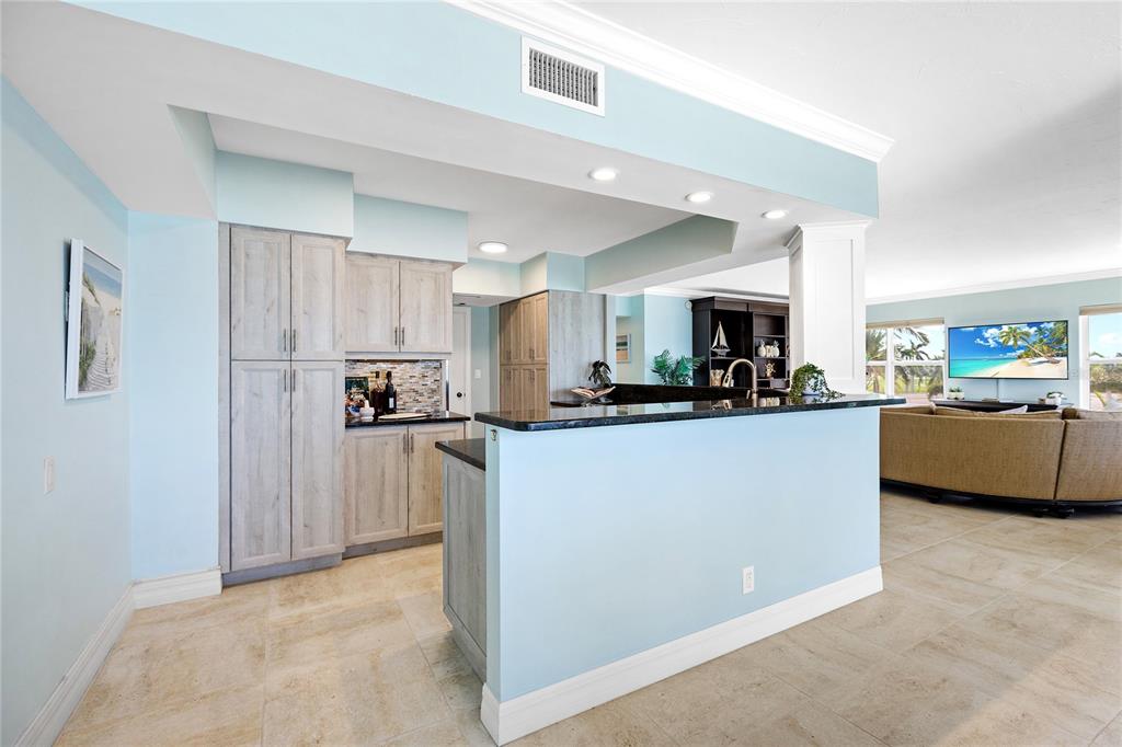 603 Longboat Club Road, Unit 304N Longboat Key, FL 34228 - Photo 9 of 43 a view of a kitchen with cabinets and refrigerator