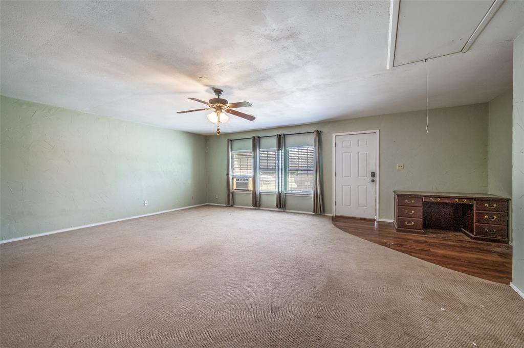 508 South Pedigo Street Pilot Point, TX 76258 - Photo 16 of 25 a view of an empty room with a ceiling fan and window