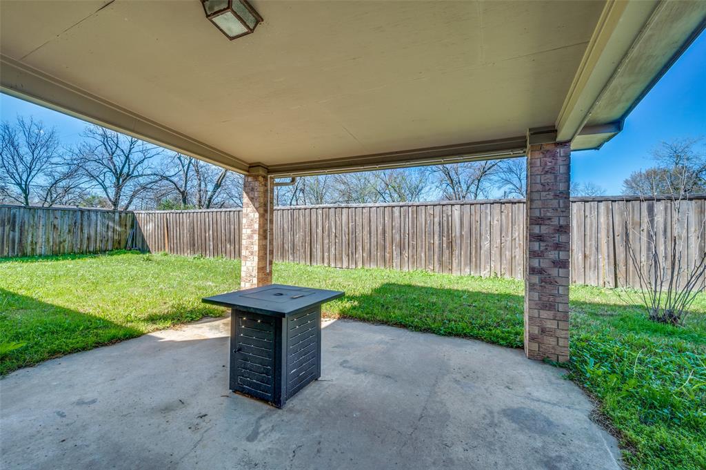 508 South Pedigo Street Pilot Point, TX 76258 - Photo 22 of 25 a view of a backyard with brick wall and a fence