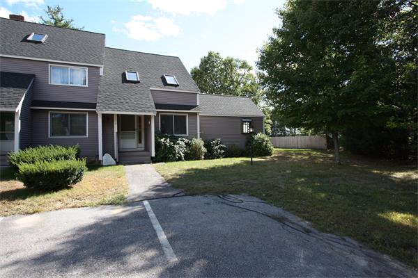 160 Ayer Road, Unit H6 Shirley, MA 01464 - Photo 1 of 1 a front view of a house with a garden and patio