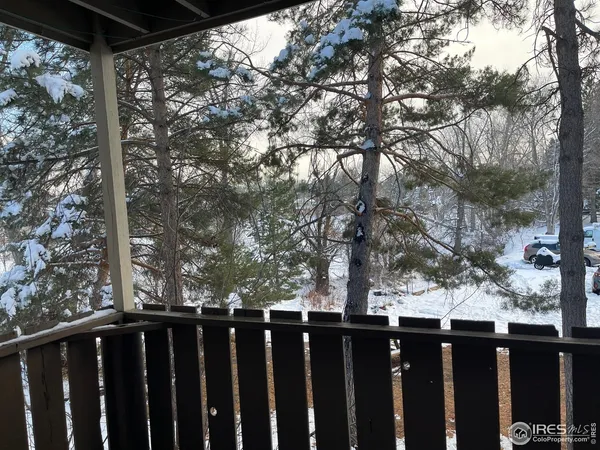a view of a balcony with wooden fence and floor