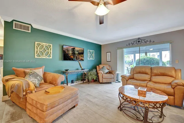 a dining area with a table chairs and a kitchen view